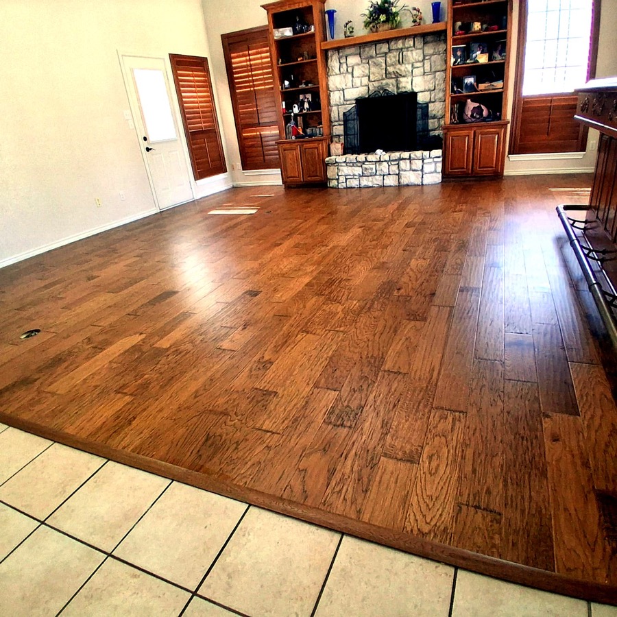 FloorFlash walnut hardwood floor installed in a DFW kitchen with white cabinetry